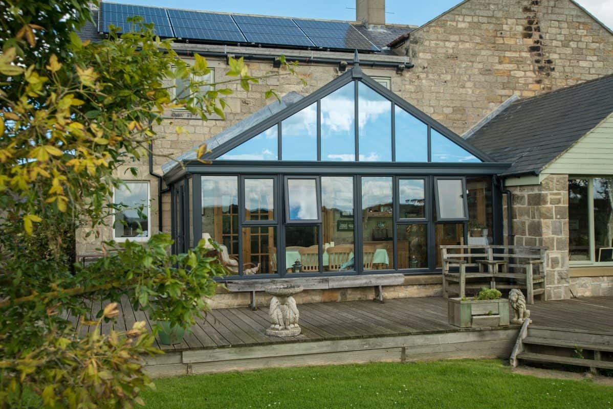 Contemporary glass conservatory with wooden deck in Bournemouth & Poole.