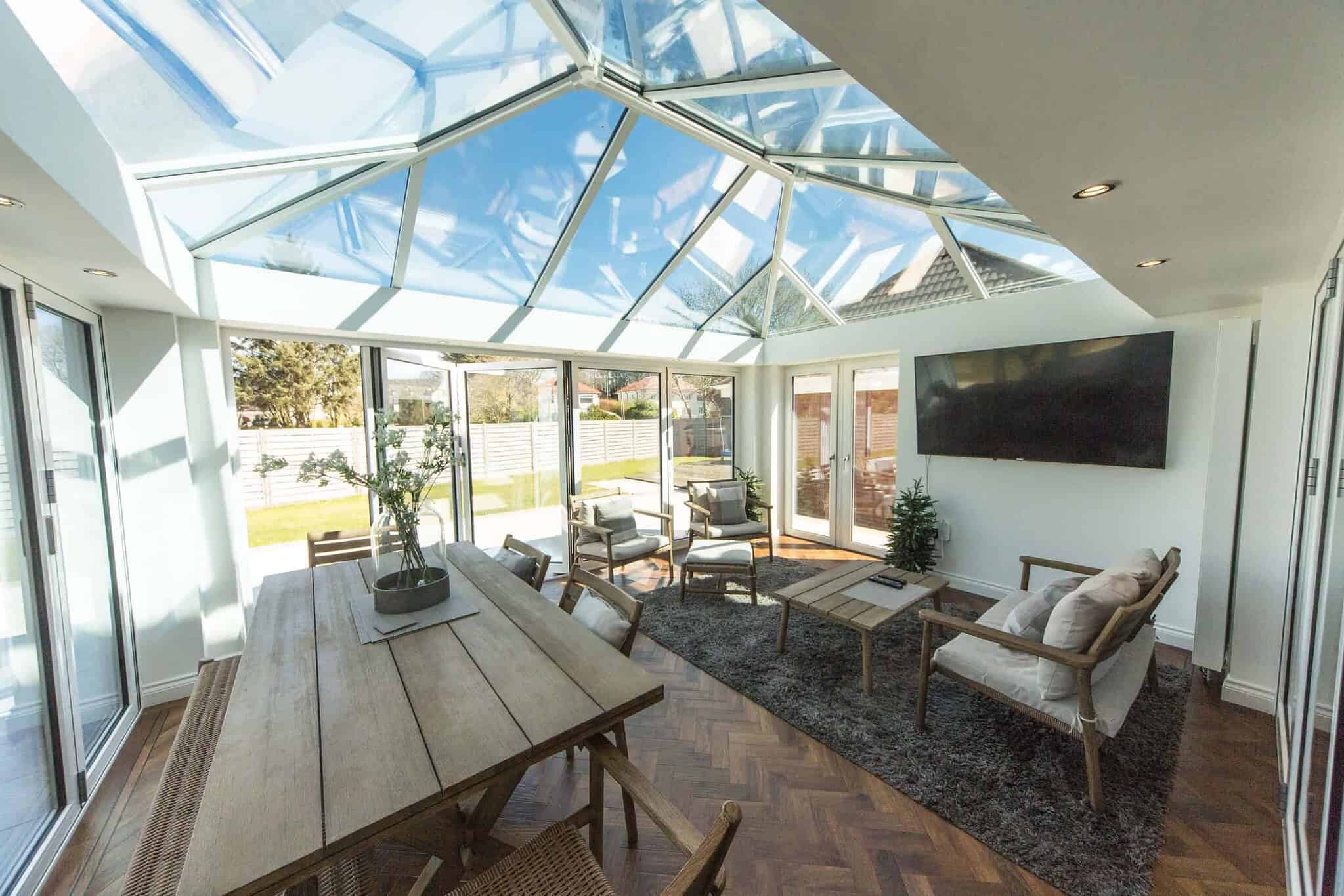 Bright conservatory with glass roof and modern furniture in Poole & Bournemouth.