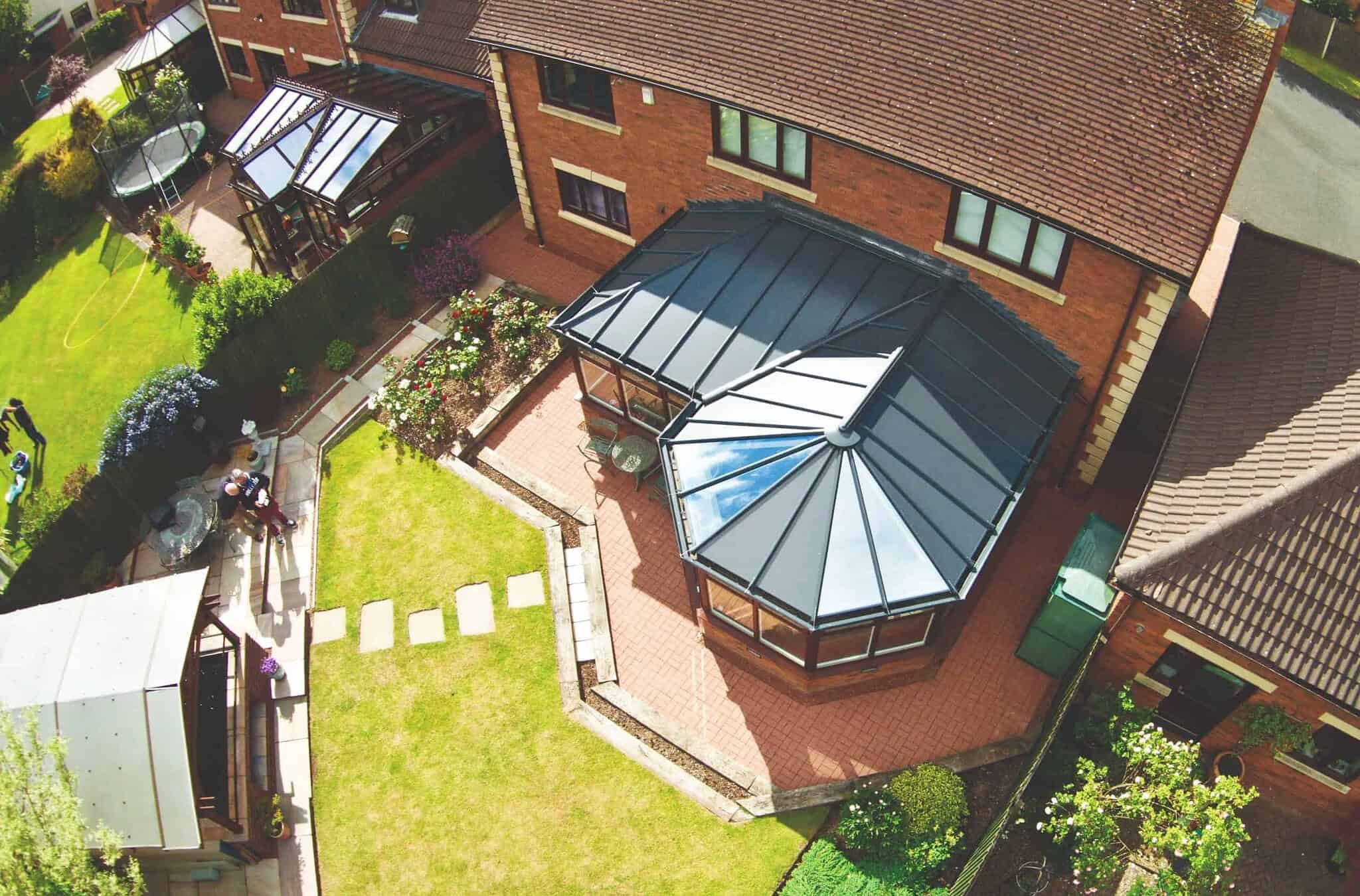 Modern conservatory extension in Poole & Bournemouth with glass roof and brick base.