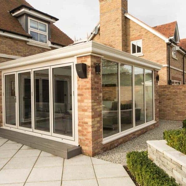 Modern conservatory extension in Poole & Bournemouth with glass walls and white frame.